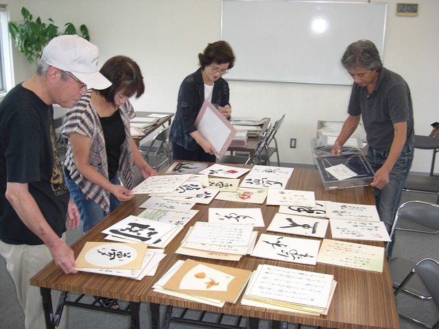 心のこもった日本画や書などの作品を整理する「水茎会」「紀北文人会」のメンバーら